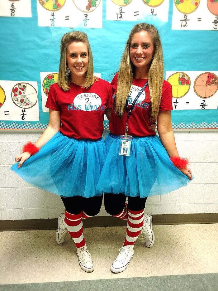 Two teachers dressed as Thing 1 and Thing 2 with red shirts and blue tutus for Read Across America